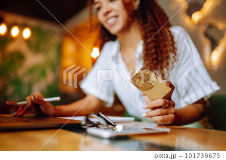 Young woman sitting at cafe making online shopping, using credit card and laptop. Online shopping Young woman sitting at cafe making online shopping, using credit card and laptop. Online shopping 101739675