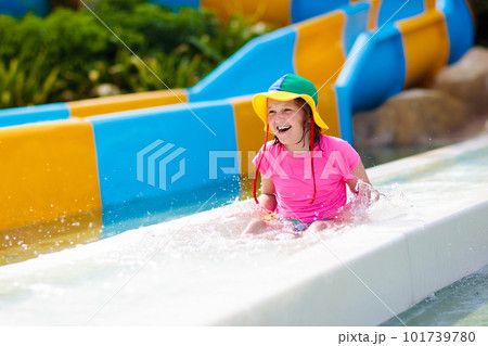 Kids on water slide in aqua park. Summer vacation Kids on water slide in aqua park. Summer vacation 101739780