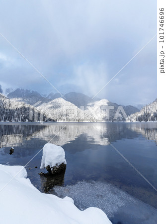 Beautiful winter landscape with mountain Ritsa lake and snow-covered trees along the shore. Great natural background with copy space for your design. Beautiful winter landscape with mountain Ritsa lake and snow-covered trees along the shore. Great natural background with copy space for your design. 101746696