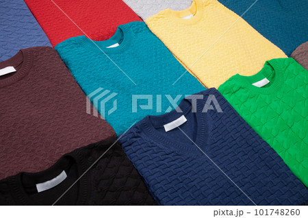Collection of knitted jumpers of various colours folded Collection of knitted jumpers of various colours folded 101748260