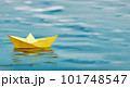 A single yellow paper boat floating on blue water - symbolic of adventurous future prospects - Generative AI 101748547