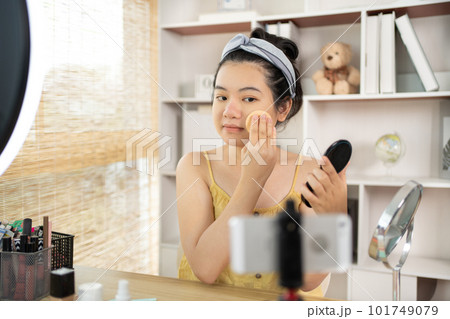Beautiful women with social media influences are teaching makeup and use cosmetics, In front of the camera to recording vlog video live streaming, Online business on concept of beauty bloggers. Beautiful women with social media influences are teaching makeup and use cosmetics, In front of the camera to recording vlog video live streaming, Online business on concept of beauty bloggers. 101749079