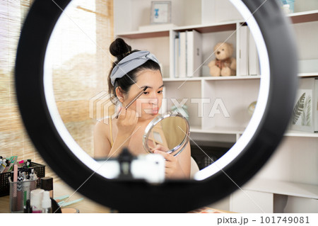 Beautiful women with social media influences are teaching makeup and use cosmetics, In front of the camera to recording vlog video live streaming, Online business on concept of beauty bloggers. Beautiful women with social media influences are teaching makeup and use cosmetics, In front of the camera to recording vlog video live streaming, Online business on concept of beauty bloggers. 101749081