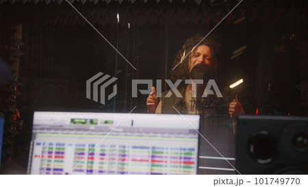 Male singer records song in soundproof room 101749770