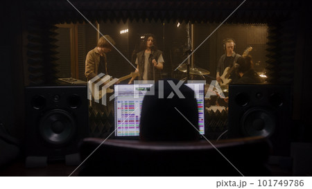 Musical band records song in music recording room 101749786