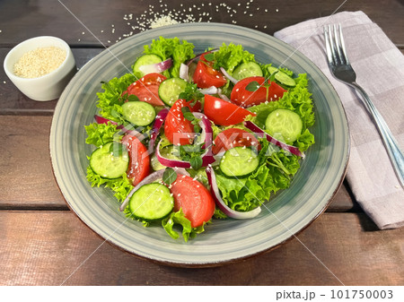 Salad of fresh tomatoes and cucumbers in a bowl Salad of fresh tomatoes and cucumbers in a bowl 101750003