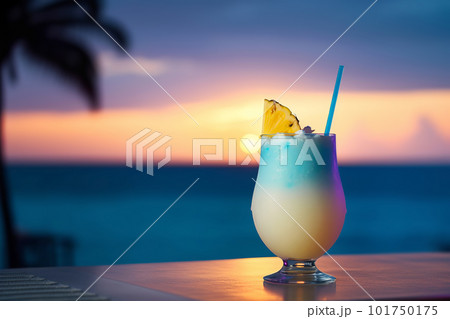 Pina Colada cocktail on sunset tropical scenery background. Generative AI illustration Pina Colada cocktail on sunset tropical scenery background. Generative AI illustration 101750175