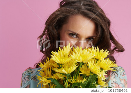 happy modern 40 years old woman in floral dress on pink 101750491