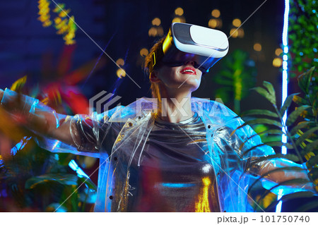 happy modern woman with open arms rejoicing in metaverse happy modern woman with open arms rejoicing in metaverse 101750740