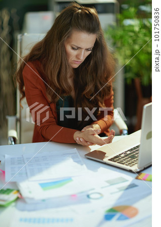 stylish small business owner woman in modern green office 101750836