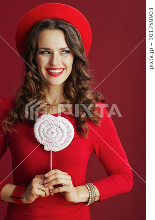 smiling elegant woman in dress and beret against background smiling elegant woman in dress and beret against background 101750903
