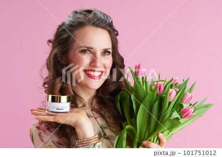 smiling 40 years old woman with long wavy brunette hair on pink 101751012