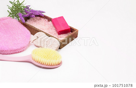Washcloth, body brush, pumice for feet, soap, sea salt with lavender on white background. Concept of self care, bath, spa. Copy space Washcloth, body brush, pumice for feet, soap, sea salt with lavender on white background. Concept of self care, bath, spa. Copy space 101751078