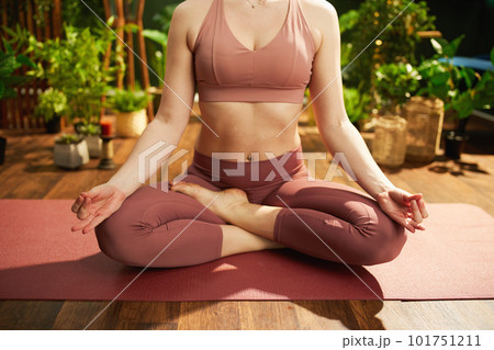 Closeup on female meditating at green home 101751211