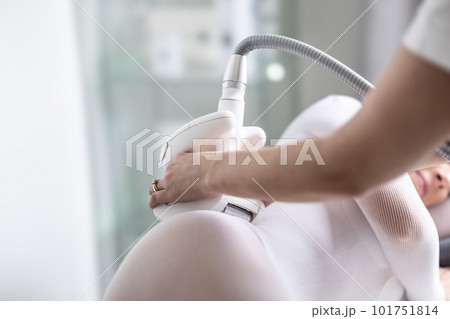 Female skincare treatment practitioner performs LPG endermology treatment of hips of a female patient Female skincare treatment practitioner performs LPG endermology treatment of hips of a female patient 101751814