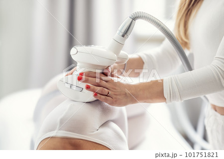 LPG enedermology equipment used for skin beautification of a female client in the cosmetics studio LPG enedermology equipment used for skin beautification of a female client in the cosmetics studio 101751821