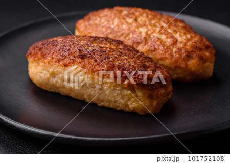 Delicious fried cutlets or meatballs from minced fish with spices and herbs 101752108