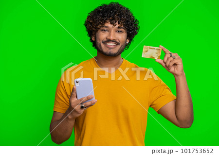 Indian man using credit bank card and smartphone while transferring money purchases online shopping Indian man using credit bank card and smartphone while transferring money purchases online shopping 101753652