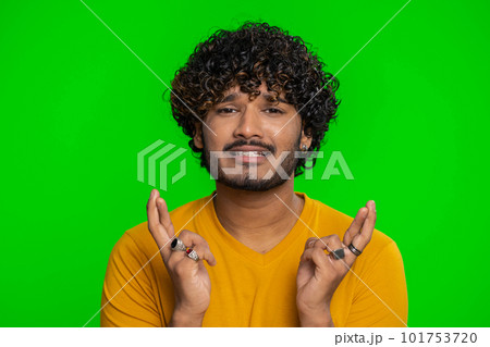 Indian man crossed fingers asking good luck, wishing good exam results, win victory lottery jackpot 101753720