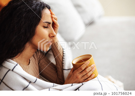 Woman experiencing severe headache due to problems and stress. 101756024