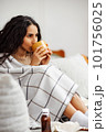 Recovery at home. Woman drinking hot drink and curing at home. 101756025