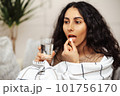 Pretty young woman taking medicine. Pill as a means for treatment or beauty. 101756170