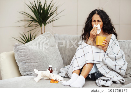A young girl caught a cold and is being treated at home. 101756175