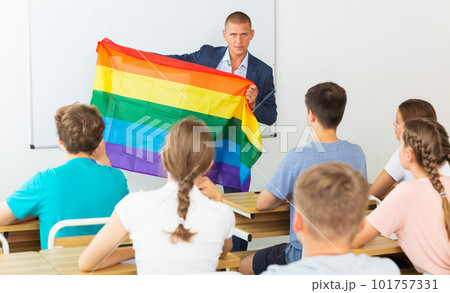 Pupils in classroom listen to teacher who explains what is LGBT 101757331