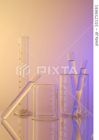 Vertical frame with laboratory equipment - beaker and test tubes containing transparent solution. Science laboratory research and development concept. Blank space for advertising. 101759691