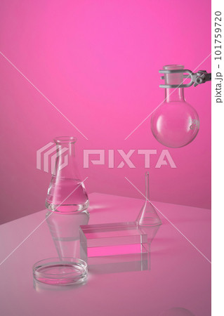 Front view of lab glassware containing transparent liquid on pink background. In the middle is a transparent podium for display product. Science and medical background 101759720
