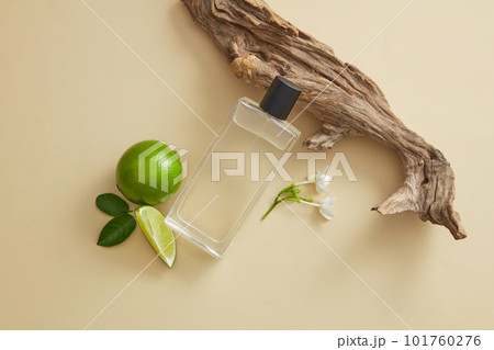 Transparent mist spray containing fluid extracted from Lime (Citrus aurantiifolia) displayed with tree branch and Lime. Lime essential oil can be used in perfume production Transparent mist spray containing fluid extracted from Lime (Citrus aurantiifolia) displayed with tree branch and Lime. Lime essential oil can be used in perfume production 101760276