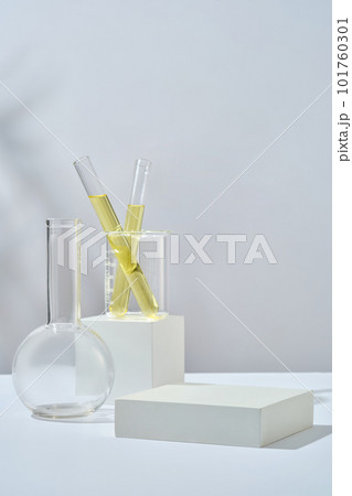 Test tube containing yellow liquid inside a beaker placed on cube podium. Empty rectangle podium for beauty product promotion of Lime (Citrus aurantiifolia) extract Test tube containing yellow liquid inside a beaker placed on cube podium. Empty rectangle podium for beauty product promotion of Lime (Citrus aurantiifolia) extract 101760301