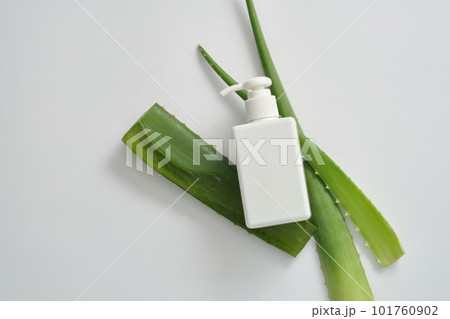 Cosmetic beauty product branding mock-up with empty pump bottle without label and fresh aloe vera leaves on white background. Natural aloe vera skin care product for healthy skin and hair. Cosmetic beauty product branding mock-up with empty pump bottle without label and fresh aloe vera leaves on white background. Natural aloe vera skin care product for healthy skin and hair. 101760902