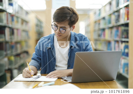 Student studying at library. 101761896