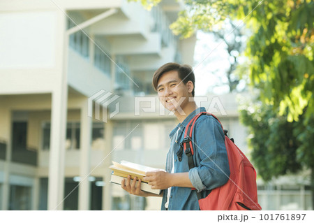 Student standing outdoor and holding books. Student standing outdoor and holding books. 101761897