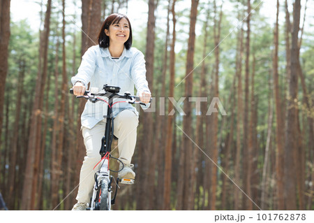 林間で電動自転車に乗る女性 101762878