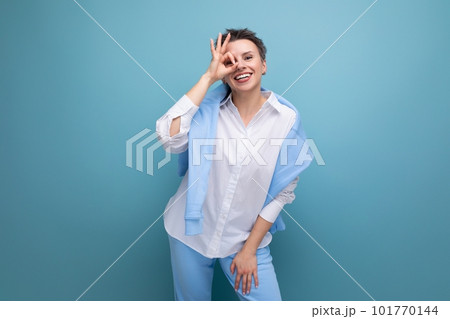 energetic positive young brunette woman with short haircut in white shirt 101770144