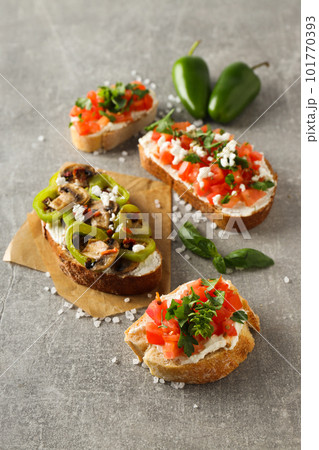Toasts with tasty grilled vegetables, concept of delicious appetizer Toasts with tasty grilled vegetables, concept of delicious appetizer 101770393
