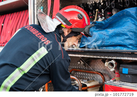 Firefighter check and maintenance equipment for working in area of fireplace office near fire truck Firefighter check and maintenance equipment for working in area of fireplace office near fire truck 101772719