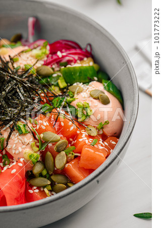 Portion of salmon poke bowl with vegetables 101773222