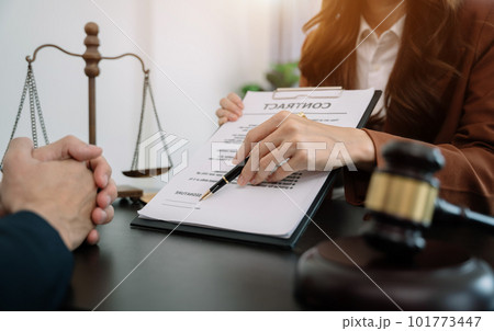 Business people and lawyers discussing contract papers sitting in the table at office in the morning. concepts of law, advice, legal services. Business people and lawyers discussing contract papers sitting in the table at office in the morning. concepts of law, advice, legal services. 101773447