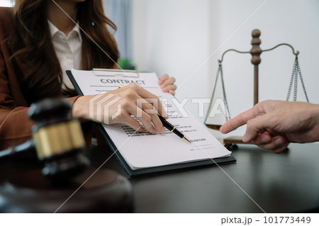 Business people and lawyers discussing contract papers sitting in the table at office in the morning. concepts of law, advice, legal services. Business people and lawyers discussing contract papers sitting in the table at office in the morning. concepts of law, advice, legal services. 101773449