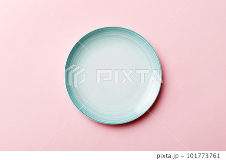 Top view of isolated of colored background empty round blue plate for food. Empty dish with space for your design 101773761