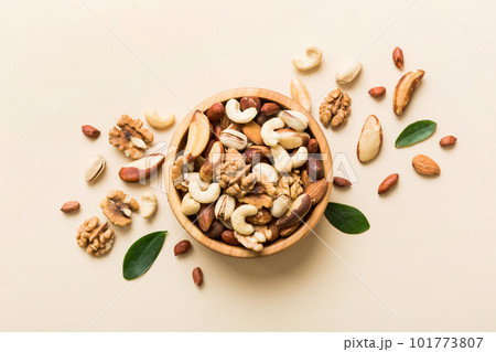 mixed nuts in bowl. Mix of various nuts on colored background. pistachios, cashews, walnuts, hazelnuts, peanuts and brazil nuts mixed nuts in bowl. Mix of various nuts on colored background. pistachios, cashews, walnuts, hazelnuts, peanuts and brazil nuts 101773807