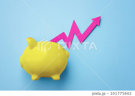 Pink graph rising out of yellow piggy bank on blue background Pink graph rising out of yellow piggy bank on blue background 101775602