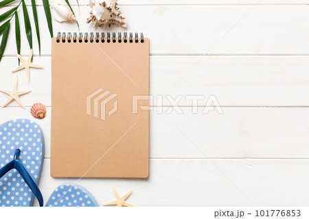Blank writing book with summer beach accessories on background, copy space. Flat lay with copy space Blank writing book with summer beach accessories on background, copy space. Flat lay with copy space 101776853
