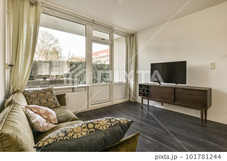 a living room with wood flooring and sliding glass door that opens onto the patio area to an outside view 101781244