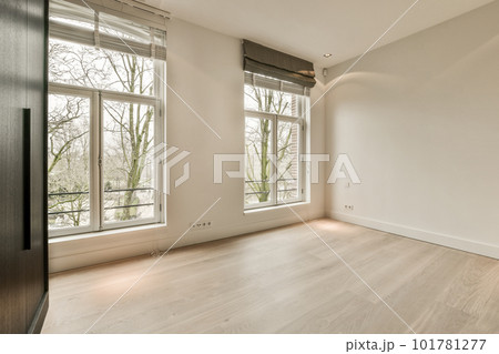 an empty room with wood flooring and large windows looking out onto the trees in the photo is taken from inside an empty room with wood flooring and large windows looking out onto the trees in the photo is taken from inside 101781277