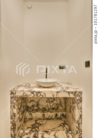 a marble sink in a white bathroom with black trim around the edge and an oval mirror on the wall above it a marble sink in a white bathroom with black trim around the edge and an oval mirror on the wall above it 101781297