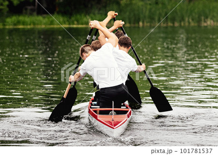rear view male junior canoeist on canoe four in canoeing competition race, sports summer games rear view male junior canoeist on canoe four in canoeing competition race, sports summer games 101781537